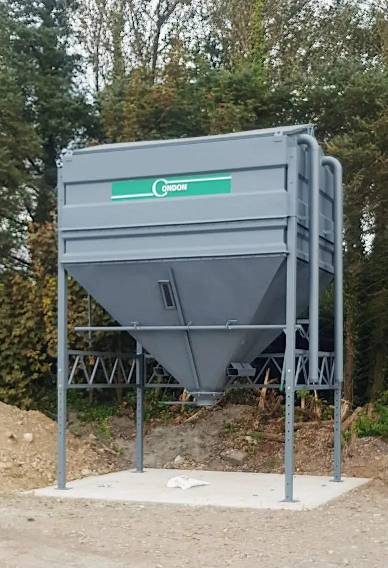 A ten-tonne bin finished in grey, standing on a freshly poured concrete pad