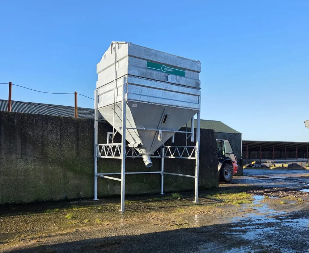 The bin from the side, showing the outlet pipe below the hopper and the adjustable legs at full height