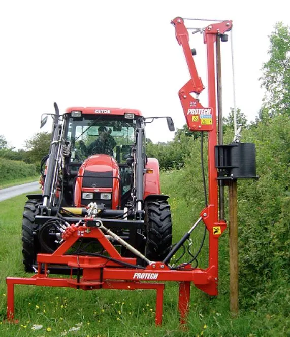 A Protech P180 post knocker mounted on the rear of a tractor, driving a fence post