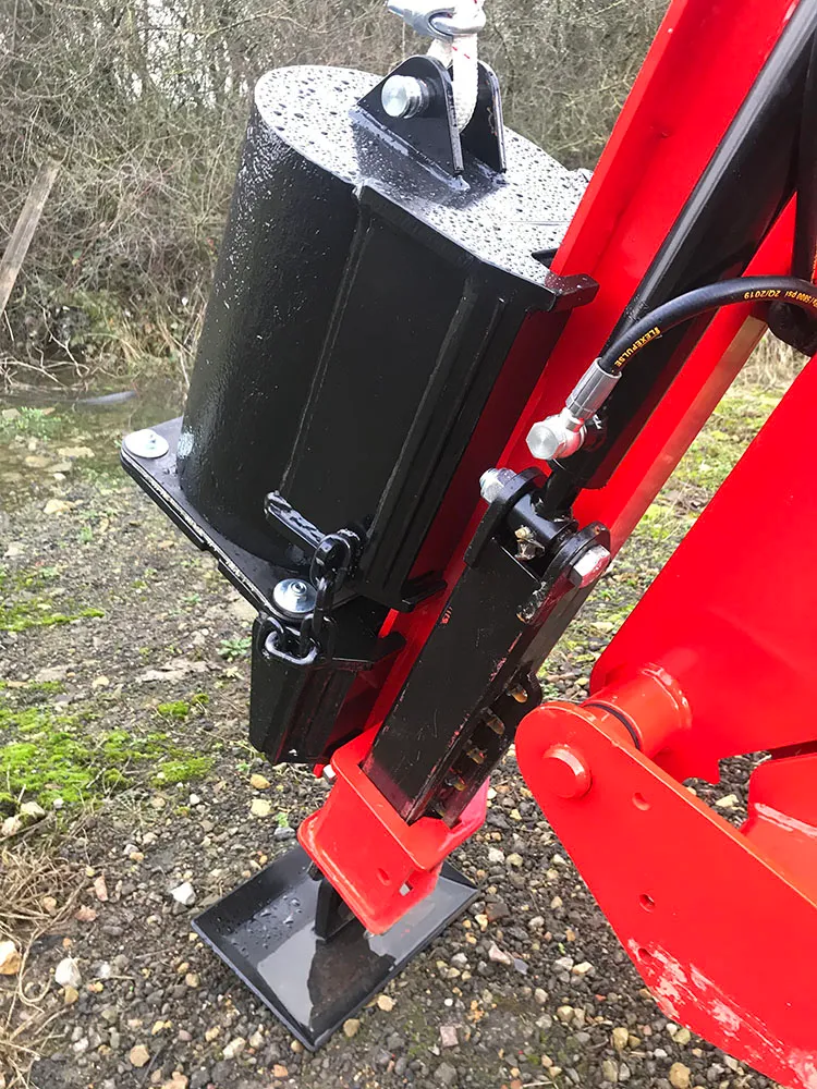 Close-up of the driver weight on its slide, with the stabiliser foot down on the ground