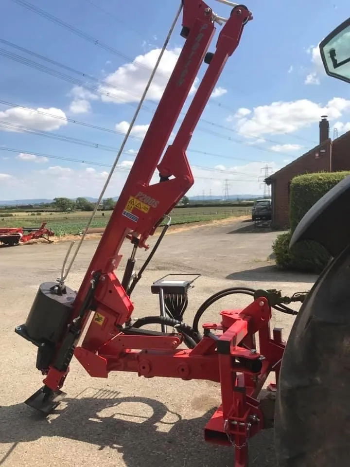 The P200S mounted on the back of a tractor in the yard, mast upright