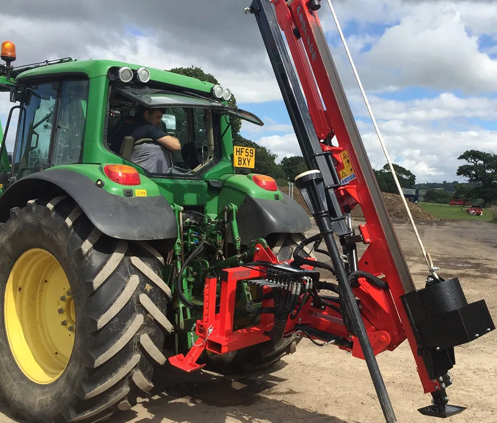 A Protech P200S hydraulic post knocker mounted on the rear of a tractor