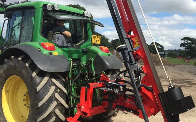 A Protech P200S hydraulic post knocker mounted on the rear of a tractor