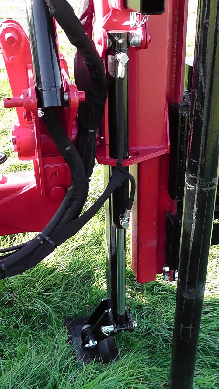 The rear leg down on the ground, steadying the machine while a post is driven