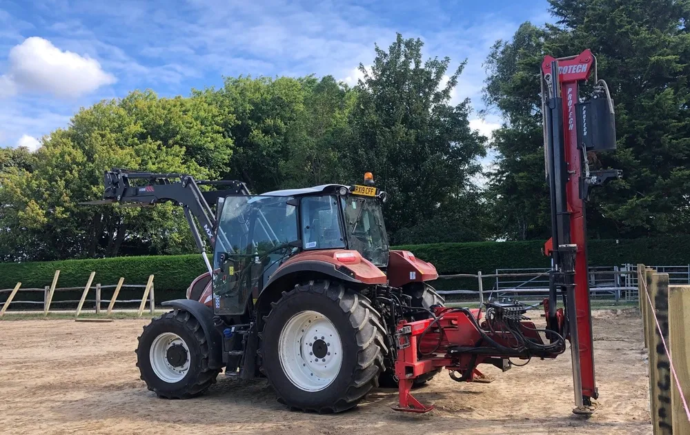 The P300S on the back of a tractor, driving the posts for a new fence line