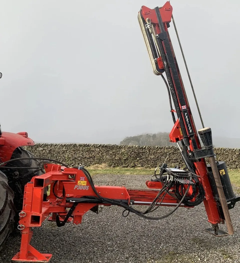 The P300S side-on with the mast up, against a dry-stone wall