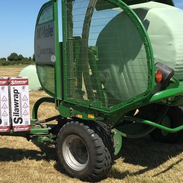 A McHale wrapper wrapping a bale in green Silawrap silage film