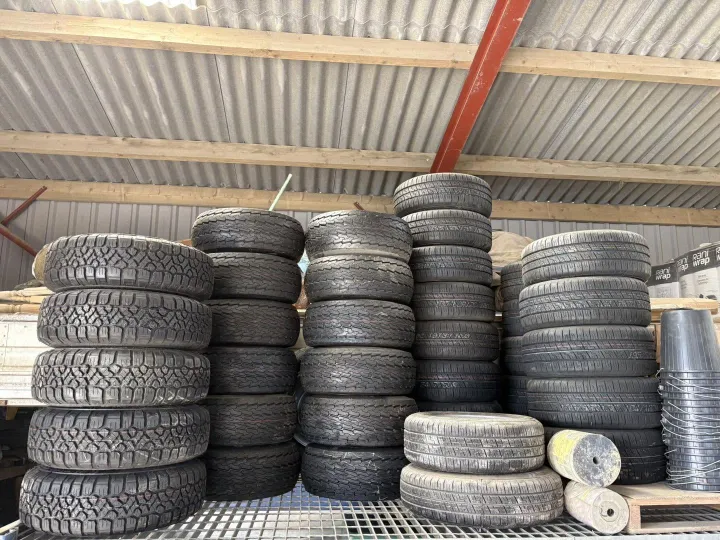 Stacks of trailer tyres in a range of sizes on the shelf at D G Jones Agri